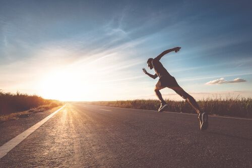 The man with runner on the street be running for exercise.